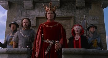Movie still from “The Princess Bride” (1987), directed by Rob Reiner – A man wearing a red robe and a crown; Medium shot, Low angle