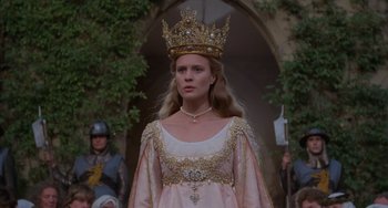 Movie still from “The Princess Bride” (1987), directed by Rob Reiner – A woman wearing a gold crown and a pink dress; Medium shot, Low angle