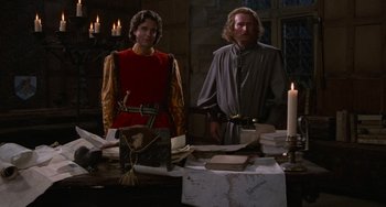 Movie still from “The Princess Bride” (1987), directed by Rob Reiner – Two men standing next to each other in front of candles; Medium shot, High angle