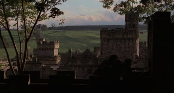 Movie still from “The Princess Bride” (1987), directed by Rob Reiner – Two people sitting on a bench in front of a castle; Extreme Wide shot, High angle