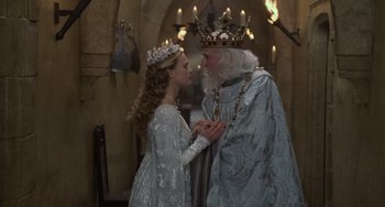 Movie still from “The Princess Bride” (1987), directed by Rob Reiner – A man and a woman dressed as a king and queen; Medium shot, High angle