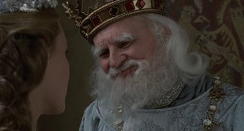 Movie still from “The Princess Bride” (1987), directed by Rob Reiner – An old man with a long white beard wearing a crown; Close Up shot, Over the shoulder angle