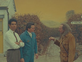 Movie still from “The Rat Catcher” (2023), directed by Wes Anderson – A group of men standing next to each other; Wide shot, High angle