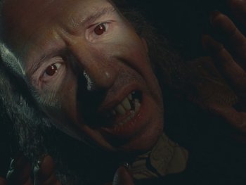 Movie still from “The Rat Catcher” (2023), directed by Wes Anderson – A man's face with red eyes; Close Up shot, High angle