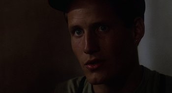 Movie still from “The Return of the Living Dead” (1985), directed by Dan O'Bannon – A person wearing a hat; Close Up shot, Over the shoulder angle