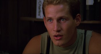 Movie still from “The Return of the Living Dead” (1985), directed by Dan O'Bannon – A person wearing a green shirt; Close Up shot, Low angle