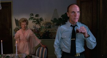 Movie still from “The Return of the Living Dead” (1985), directed by Dan O'Bannon – A man and a woman are drinking a beverage; Medium shot, Over the shoulder angle