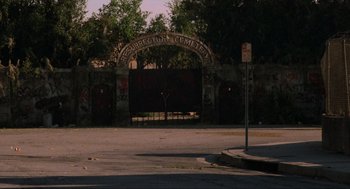 Movie still from “The Return of the Living Dead” (1985), directed by Dan O'Bannon – An empty street with graffiti on the wall; Extreme Wide shot, High angle