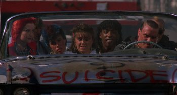 Movie still from “The Return of the Living Dead” (1985), directed by Dan O'Bannon – A group of people in the back seat of a car; Close Up shot, Low angle