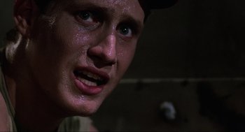 Movie still from “The Return of the Living Dead” (1985), directed by Dan O'Bannon – A person with sweat on their face; Close Up shot, Low angle