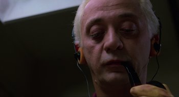 Movie still from “The Return of the Living Dead” (1985), directed by Dan O'Bannon – An older man wearing headphones while listening to music; Close Up shot, Low angle
