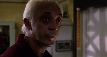Movie still from “The Return of the Living Dead” (1985), directed by Dan O'Bannon – A person with white hair; Close Up shot, Low angle