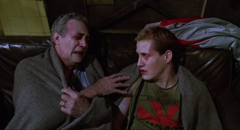 Movie still from “The Return of the Living Dead” (1985), directed by Dan O'Bannon – A man and a man with a towel on his face; Medium shot, Over the shoulder angle
