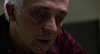 Movie still from “The Return of the Living Dead” (1985), directed by Dan O'Bannon – An older man with white hair looking down at his face; Close Up shot, Low angle