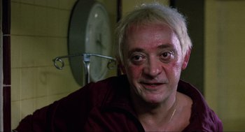 Movie still from “The Return of the Living Dead” (1985), directed by Dan O'Bannon – A person wearing a red shirt; Close Up shot, Low angle