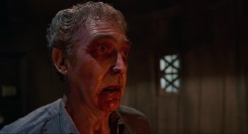 Movie still from “The Return of the Living Dead” (1985), directed by Dan O'Bannon – An old man with a bloody face looking at the camera; Close Up shot, Low angle