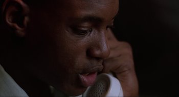 Movie still from “The Return of the Living Dead” (1985), directed by Dan O'Bannon – A person talking on a phone; Close Up shot, Low angle