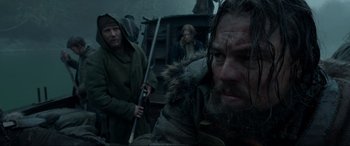 Movie still from “The Revenant” (2015), directed by Alejandro G. Iñárritu – A man with a long beard is holding a sword; Close Up shot, Low angle