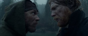Movie still from “The Revenant” (2015), directed by Alejandro G. Iñárritu – Two men face each other in a foggy forest; Close Up shot, Low angle