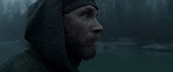 Movie still from “The Revenant” (2015), directed by Alejandro G. Iñárritu – A person with a beard wearing a hood; Close Up shot, Low angle