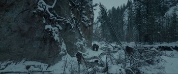 Movie still from “The Revenant” (2015), directed by Alejandro G. Iñárritu – A group of people standing on top of a snow covered slope; Extreme Wide shot, High angle