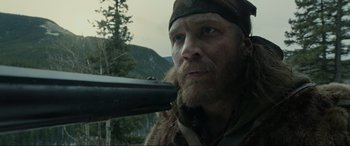 Movie still from “The Revenant” (2015), directed by Alejandro G. Iñárritu – A person holding a gun; Close Up shot, Low angle