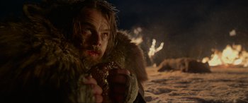 Movie still from “The Revenant” (2015), directed by Alejandro G. Iñárritu – A man in a fur coat holding something in his hand; Close Up shot, Low angle