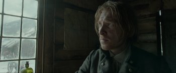 Movie still from “The Revenant” (2015), directed by Alejandro G. Iñárritu – A person with long blonde hair; Close Up shot, Low angle