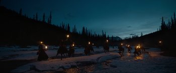Movie still from “The Revenant” (2015), directed by Alejandro G. Iñárritu – A group of people riding horses through the snow; Extreme Wide shot, High angle