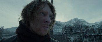 Movie still from “The Revenant” (2015), directed by Alejandro G. Iñárritu – A person with long brown hair; Close Up shot, Low angle