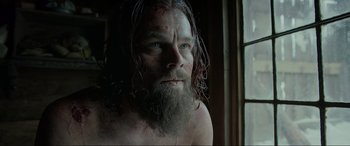 Movie still from “The Revenant” (2015), directed by Alejandro G. Iñárritu – A man with long hair and a long beard; Close Up shot, Low angle