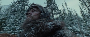 Movie still from “The Revenant” (2015), directed by Alejandro G. Iñárritu – A person wearing a fur coat; Close Up shot, Low angle