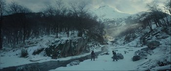 Movie still from “The Revenant” (2015), directed by Alejandro G. Iñárritu – Two people are skiing down a snowy hill; Extreme Wide shot, High angle