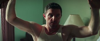 Movie still from “The Ritual Killer” (2023), directed by George Gallo – A person in a white shirt; Close Up shot, Low angle