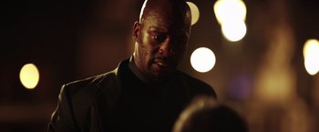 Movie still from “The Ritual Killer” (2023), directed by George Gallo – A man with a beard is standing in the dark; Close Up shot, Low angle