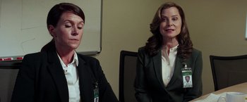 Movie still from “The Ritual Killer” (2023), directed by George Gallo – Two women in suits sitting in front of each other; Close Up shot, Over the shoulder angle