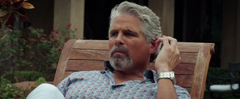 Movie still from “The Ritual Killer” (2023), directed by George Gallo – An older man sitting on top of a wooden bench; Close Up shot, Over the shoulder angle