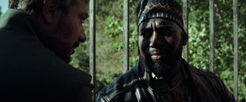 Movie still from “The Ritual Killer” (2023), directed by George Gallo – A man with a beard is talking to another man; Close Up shot, Over the shoulder angle