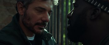 Movie still from “The Ritual Killer” (2023), directed by George Gallo – A man and a woman talking to each other; Close Up shot, Over the shoulder angle