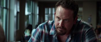 Movie still from “The Ritual Killer” (2023), directed by George Gallo – A person wearing a plaid shirt; Close Up shot, Over the shoulder angle