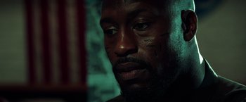 Movie still from “The Ritual Killer” (2023), directed by George Gallo – A person with a beard; Close Up shot, Low angle