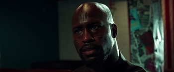 Movie still from “The Ritual Killer” (2023), directed by George Gallo – A person with a face tattoo; Close Up shot, Low angle