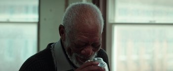 Movie still from “The Ritual Killer” (2023), directed by George Gallo – An older man is drinking a glass of water; Close Up shot, High angle