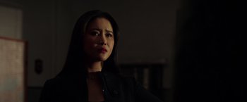 Movie still from “The Ritual Killer” (2023), directed by George Gallo – A woman with long dark brown hair wearing a black jacket; Close Up shot, Low angle