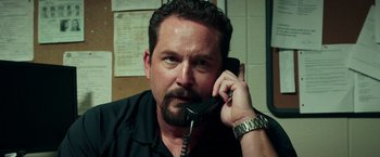 Movie still from “The Ritual Killer” (2023), directed by George Gallo – A person talking on a phone; Close Up shot, Over the shoulder angle