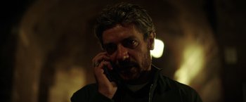 Movie still from “The Ritual Killer” (2023), directed by George Gallo – A person talking on a cell phone; Close Up shot, Low angle