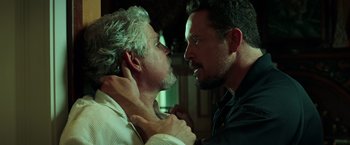 Movie still from “The Ritual Killer” (2023), directed by George Gallo – Two men are fighting in a dark room; Close Up shot, Over the shoulder angle