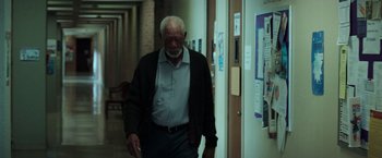 Movie still from “The Ritual Killer” (2023), directed by George Gallo – An older man walking down a hallway in a building; Wide shot, Low angle