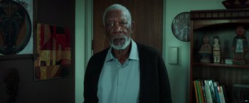 Movie still from “The Ritual Killer” (2023), directed by George Gallo – An older man standing in front of a door; Medium shot, High angle