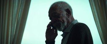 Movie still from “The Ritual Killer” (2023), directed by George Gallo – An older man talking on a cell phone; Close Up shot, Low angle